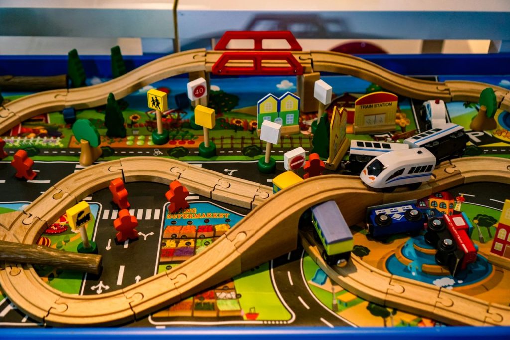 Vibrant and detailed wooden toy train set with roads, bridges, and signs for imaginative play.